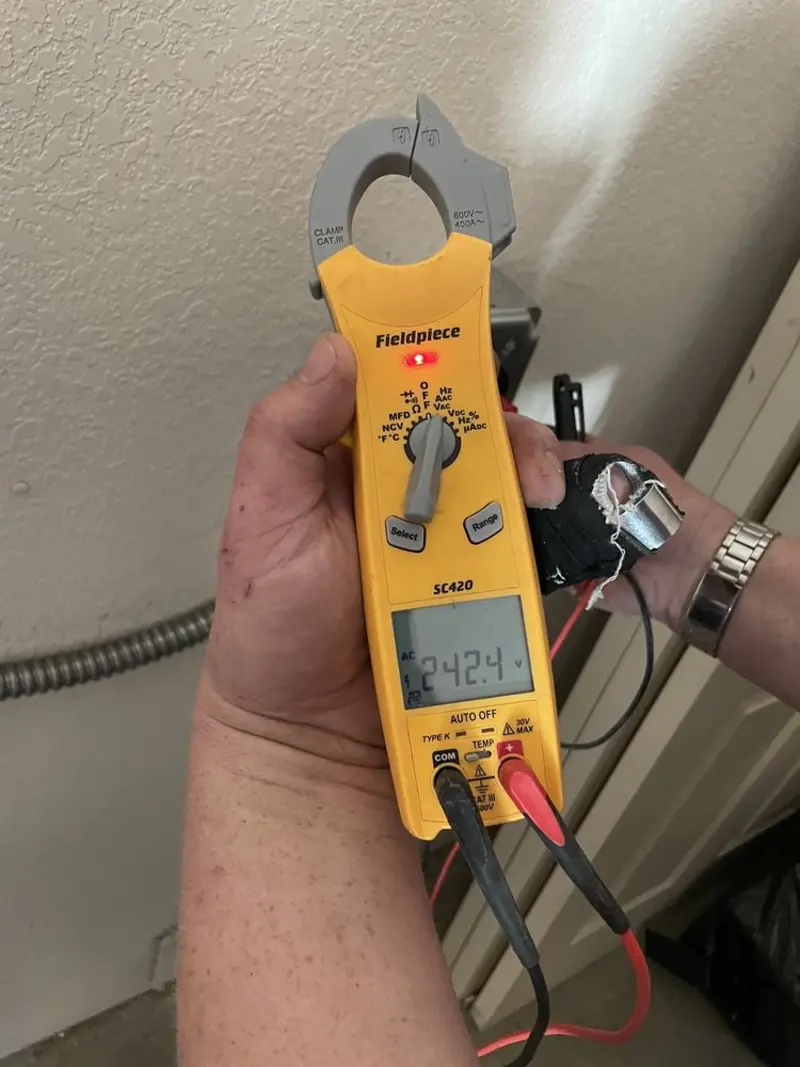 Voltage testing with clamp meter during Electrical Installation Services in Frontenac